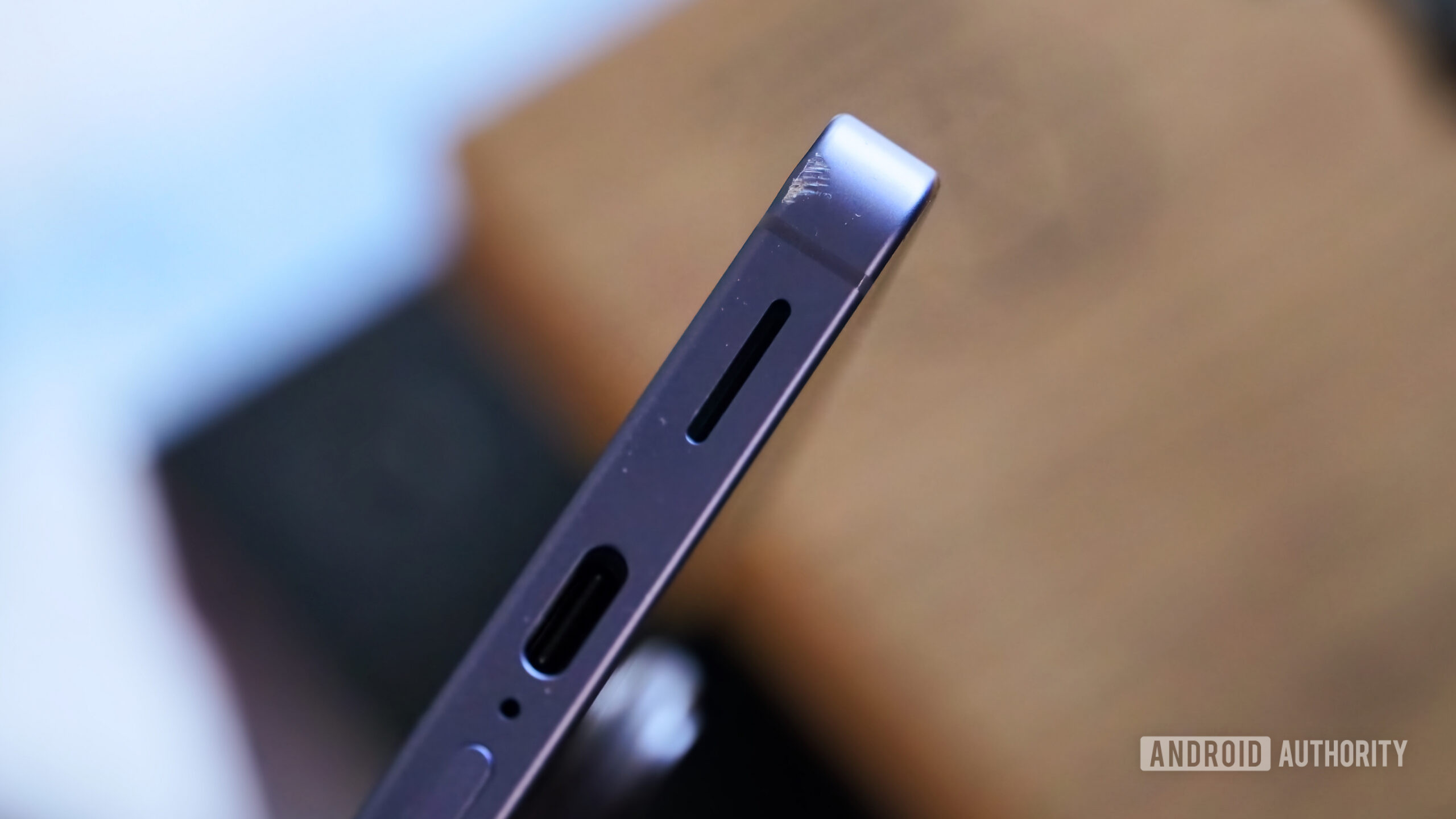 Scuffs on the bottom of a purple Galaxy S26.