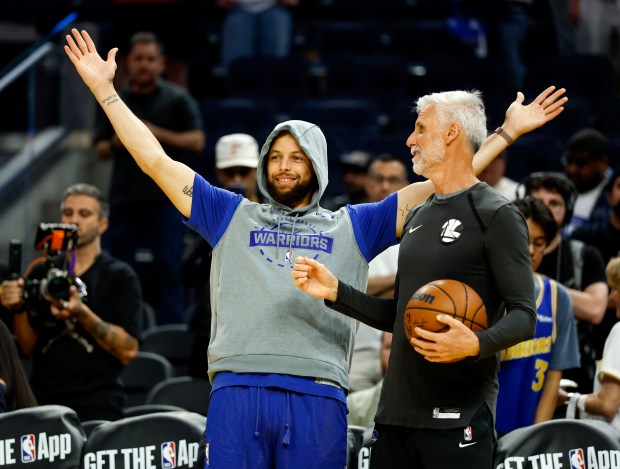 Golden State Warriors' Stephen Curry (30) warms up with assistant coach Bruce Fraser before the Warriors game against the Houston Rockets at the Chase Center in San Francisco, Calif., on Sunday, April 5, 2026. (Nhat V. Meyer/Bay Area News Group)