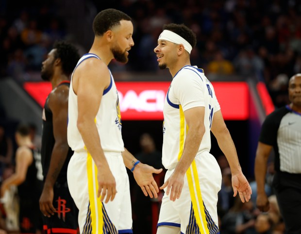 Golden State Warriors' Stephen Curry (30) high-fives Golden State Warriors' Seth Curry (31) during their game against the Houston Rockets in the second quarter at the Chase Center in San Francisco, Calif., on Sunday, April 5, 2026. (Nhat V. Meyer/Bay Area News Group)