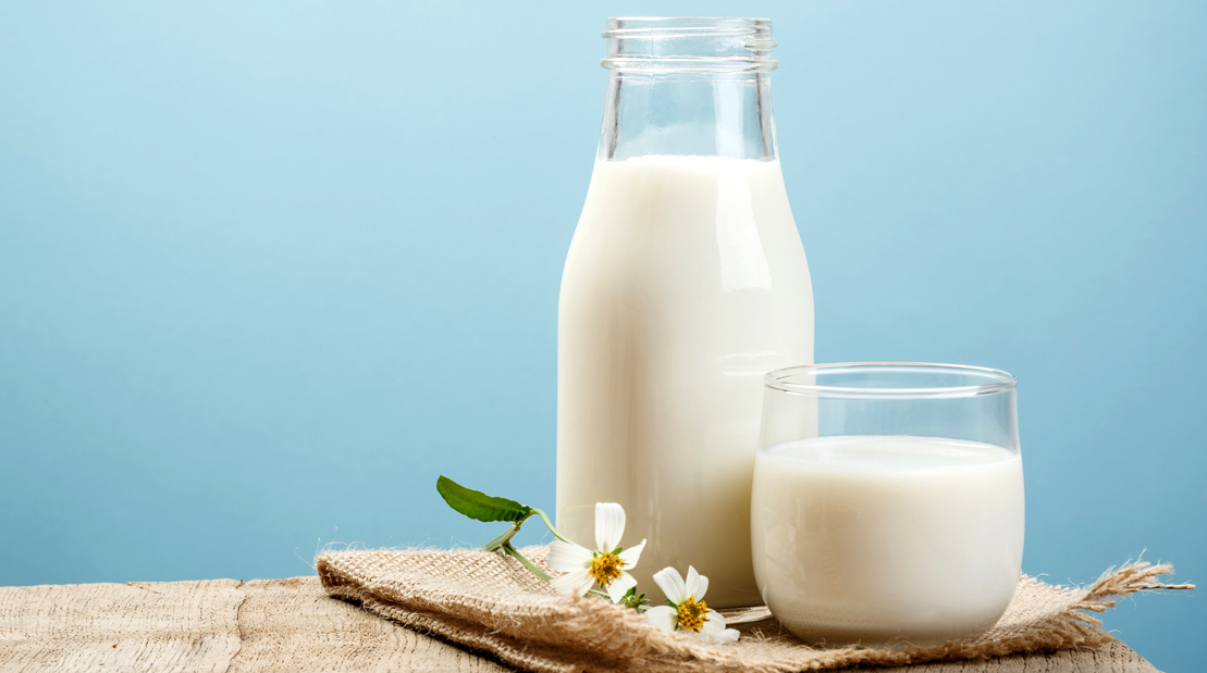 Bottle-and-Glass-Of-Milk-On-Wooden-Table