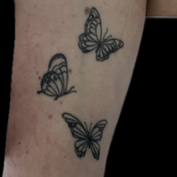 A tattoo of three butterflies is shown on the arm of an unidentified woman who was struck by lightning Thursday. (Provided by the Boulder County Sheriff's Office)