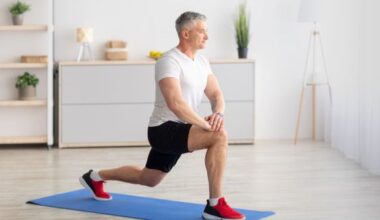 Older man at home lunging on a yoga mat