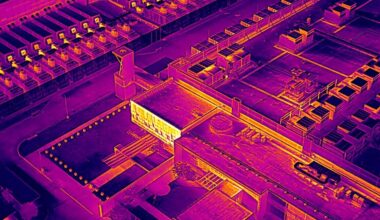 A data center in Garland, Texas as seen through a drone's thermal imaging camera that primarily displays purple, orange, red and yellow colors to show heat signature.