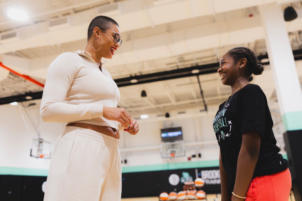 Satou Sabally interacts with one of the students from Uncommon Excellence Girls Charter Middle School.