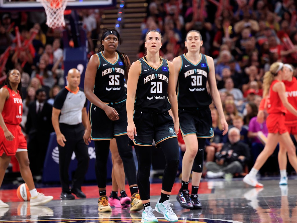 Sabrina Ionescu #20 ,Jonquel Jones #35 and Breanna Stewart #30 of the New York Liberty looks on during the game against the Indiana Fever on July 6, 2024 at Gainbridge Fieldhouse in Indianapolis, Indiana.