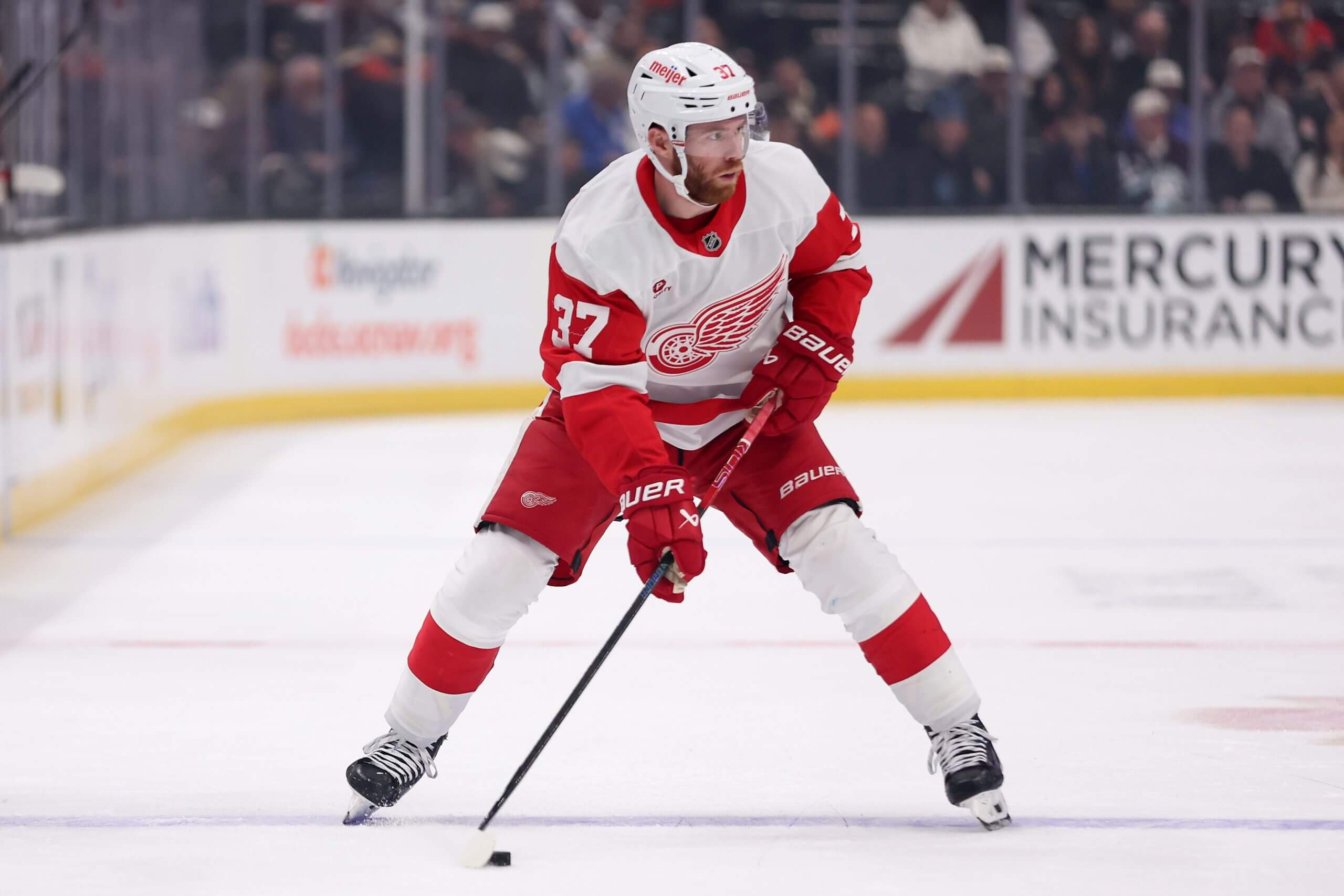 J.T. Compher looks to his left while in possession of the puck in a game against the Ducks.