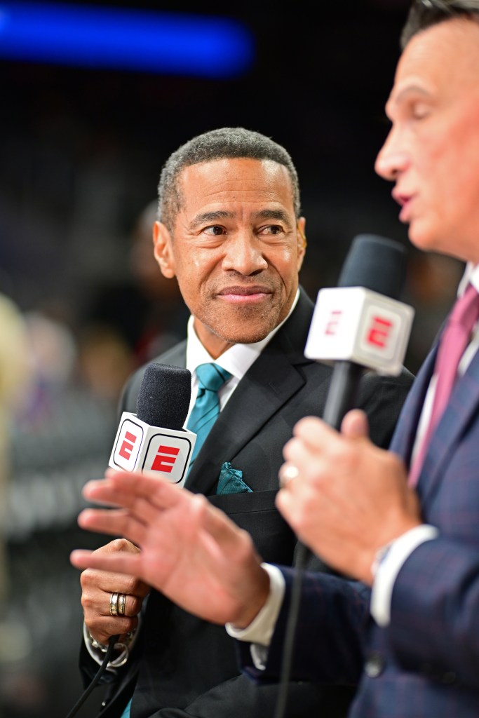 ESPN analyst Clark Kellogg looks at an interviewer with two microphones.
