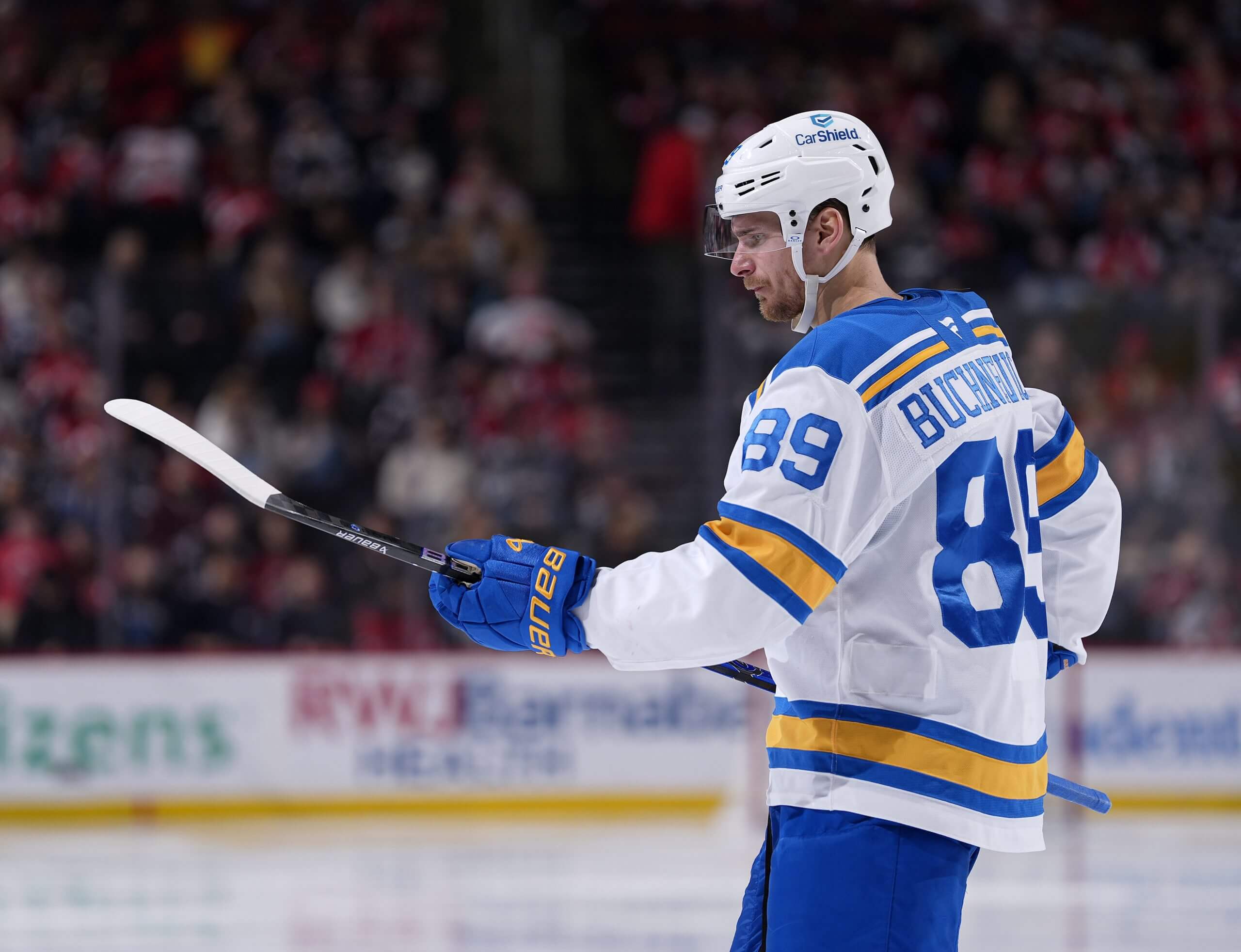 Pavel Buchnevich studies the blade of his stick with a pensive expression during a pause in play.