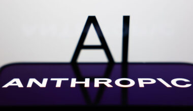 AI sign displayed on a screen and Anthropic logo displayed on a phone screen are seen in this illustration photo.
