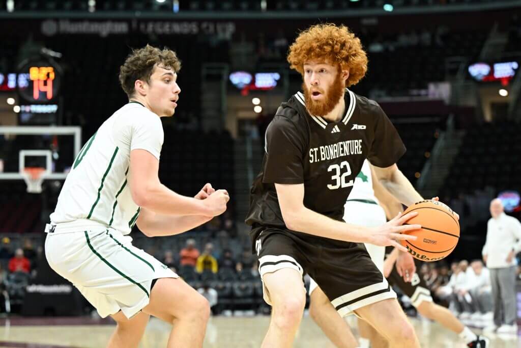 Joseph Grahovac holds the basketball away from a defender