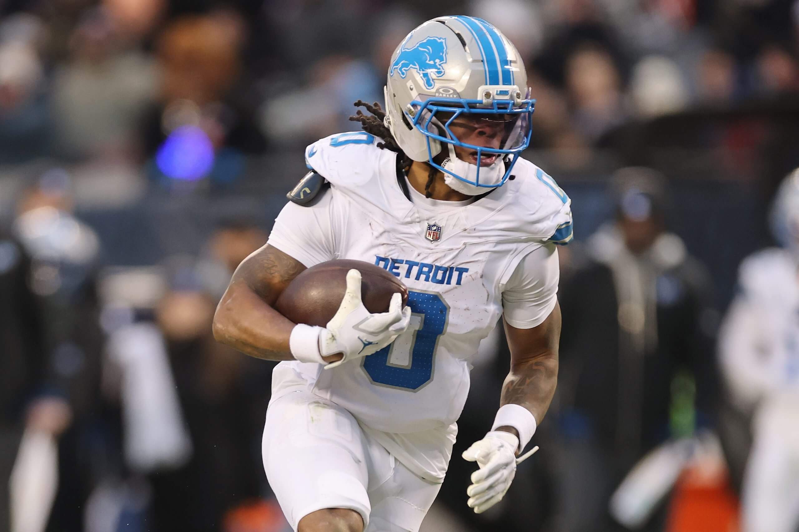 Jahmyr Gibbs #0 of the Detroit Lions runs with the ball against the Chicago Bears at Soldier Field