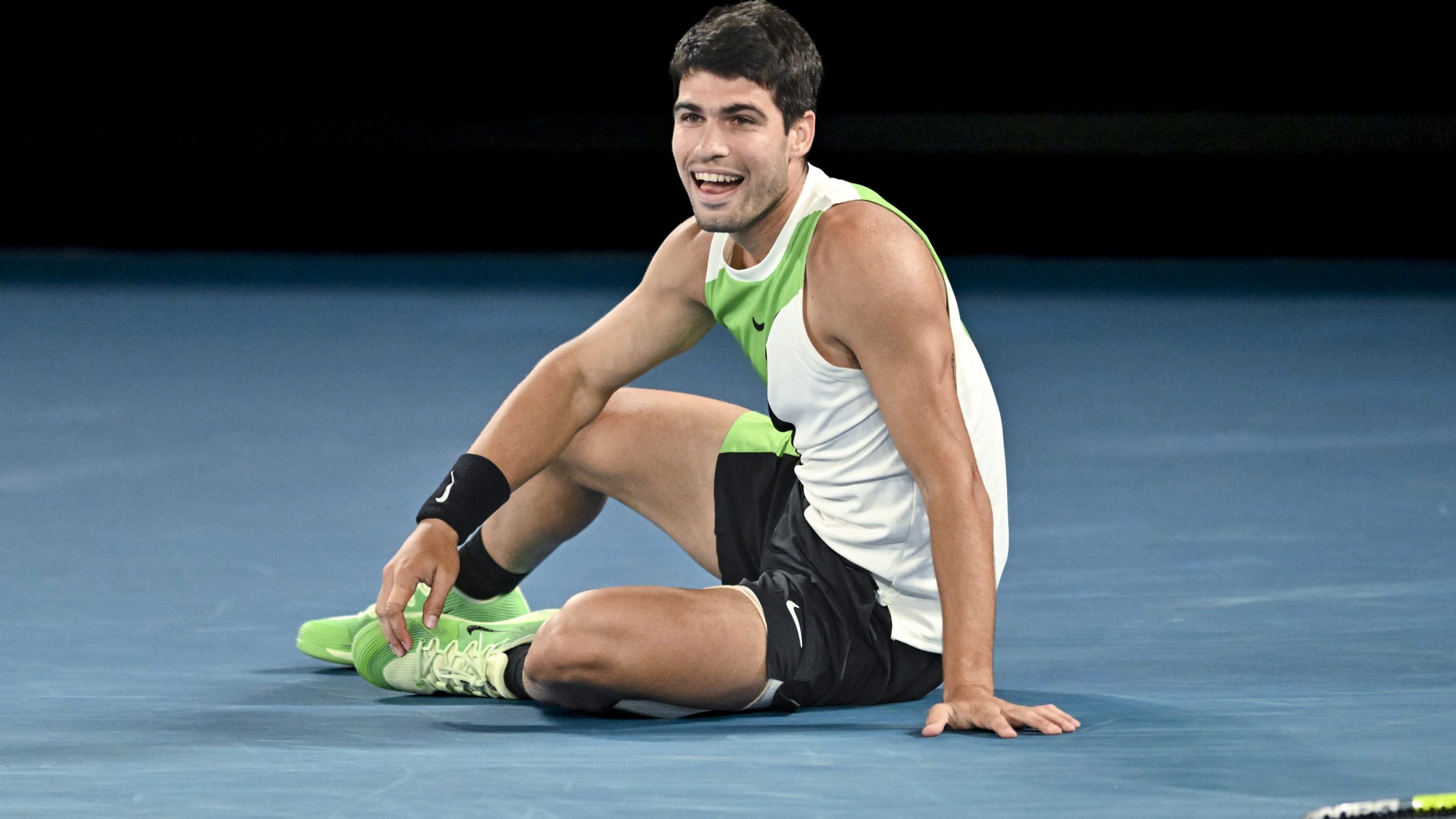 Carlos Alcaraz celebrates on the court after winning the Australian Open.