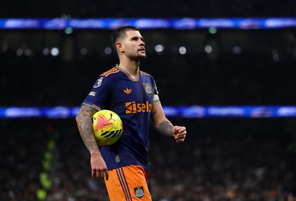 Bruno Guimaraes walks with ball under his arm for Newcastle.