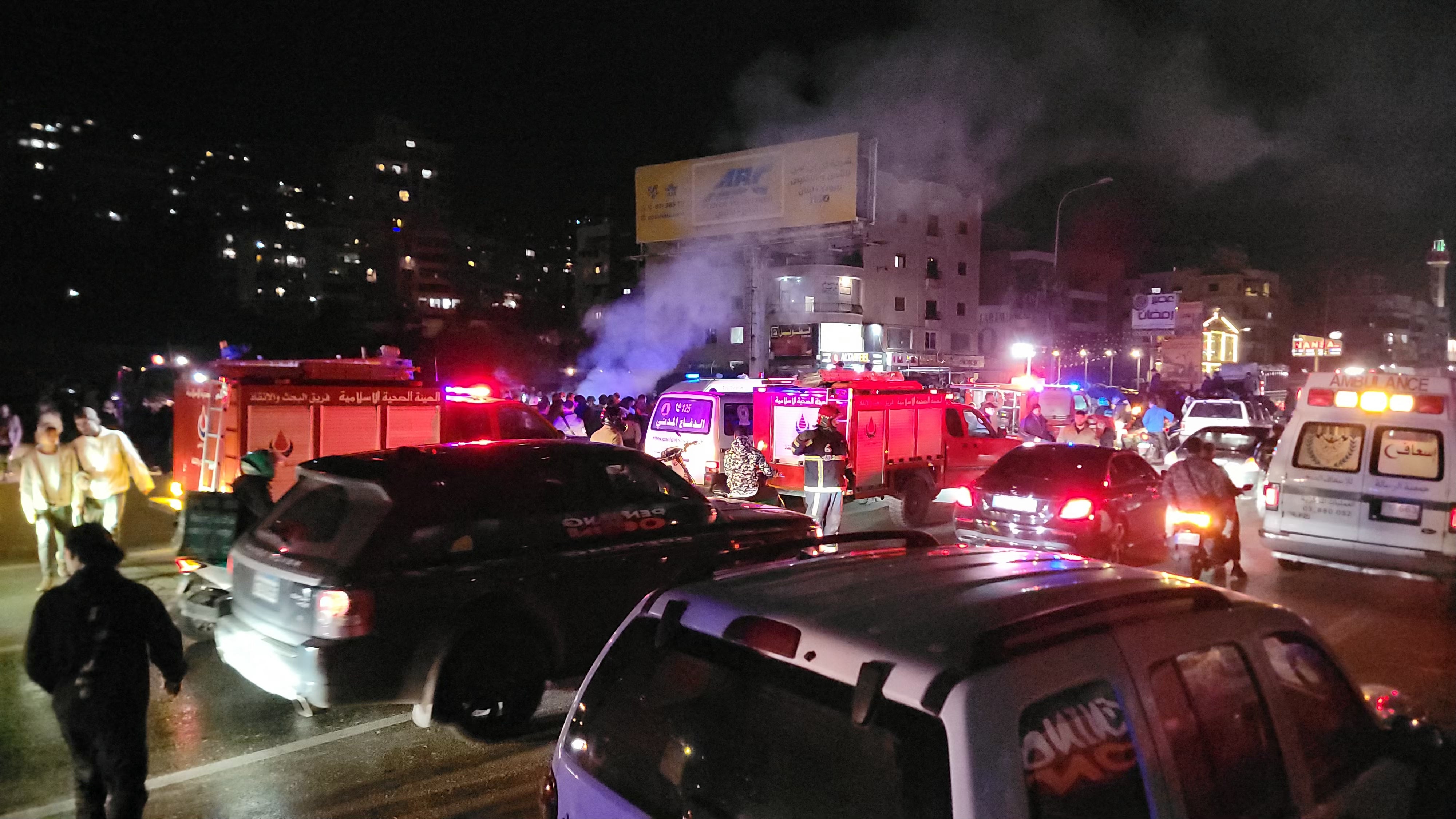 First responders rush to the site where a vehicle was targeted by an Israeli airstrike in the area of Khalde south of Beirut on April 1, 2026. (Photo by Fadel ITANI / AFP via Getty Images) /