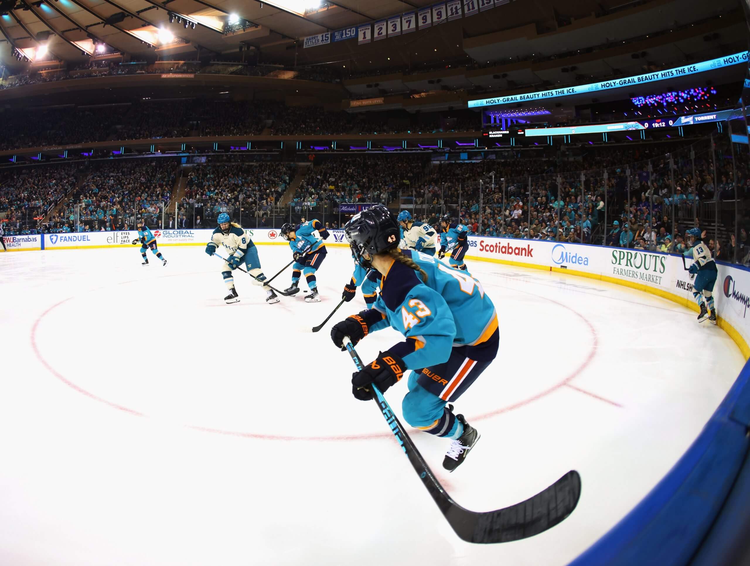 A New York Sirens player skates past a camera with a wide-angle lens.
