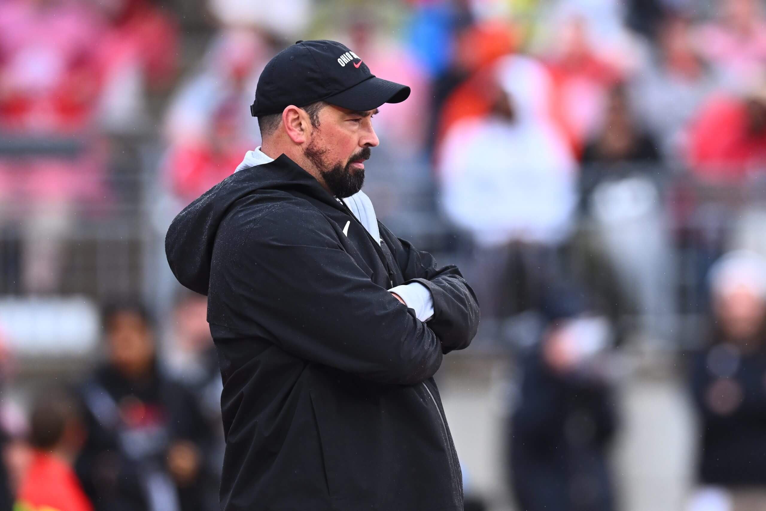 Ryan stands with his arms crossed. 