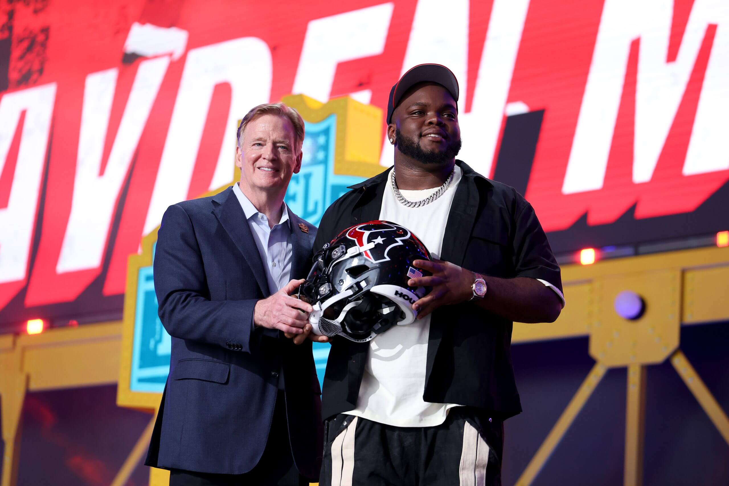 Kayden McDonald (R) of Ohio State poses with NFL Commissioner Roger Goodell (L) celebrates after being selected thirty-sixth overall pick by the Houston Texans during Round Two of the 2026 NFL Draft at Acrisure Stadium on April 24, 2026 in Pittsburgh, Pennsylvania.