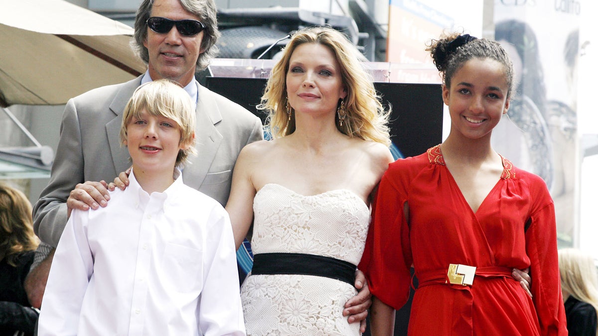 Actress Michelle Pfeiffer standing with husband David E. Kelley and their children at Hollywood Walk of Fame ceremony