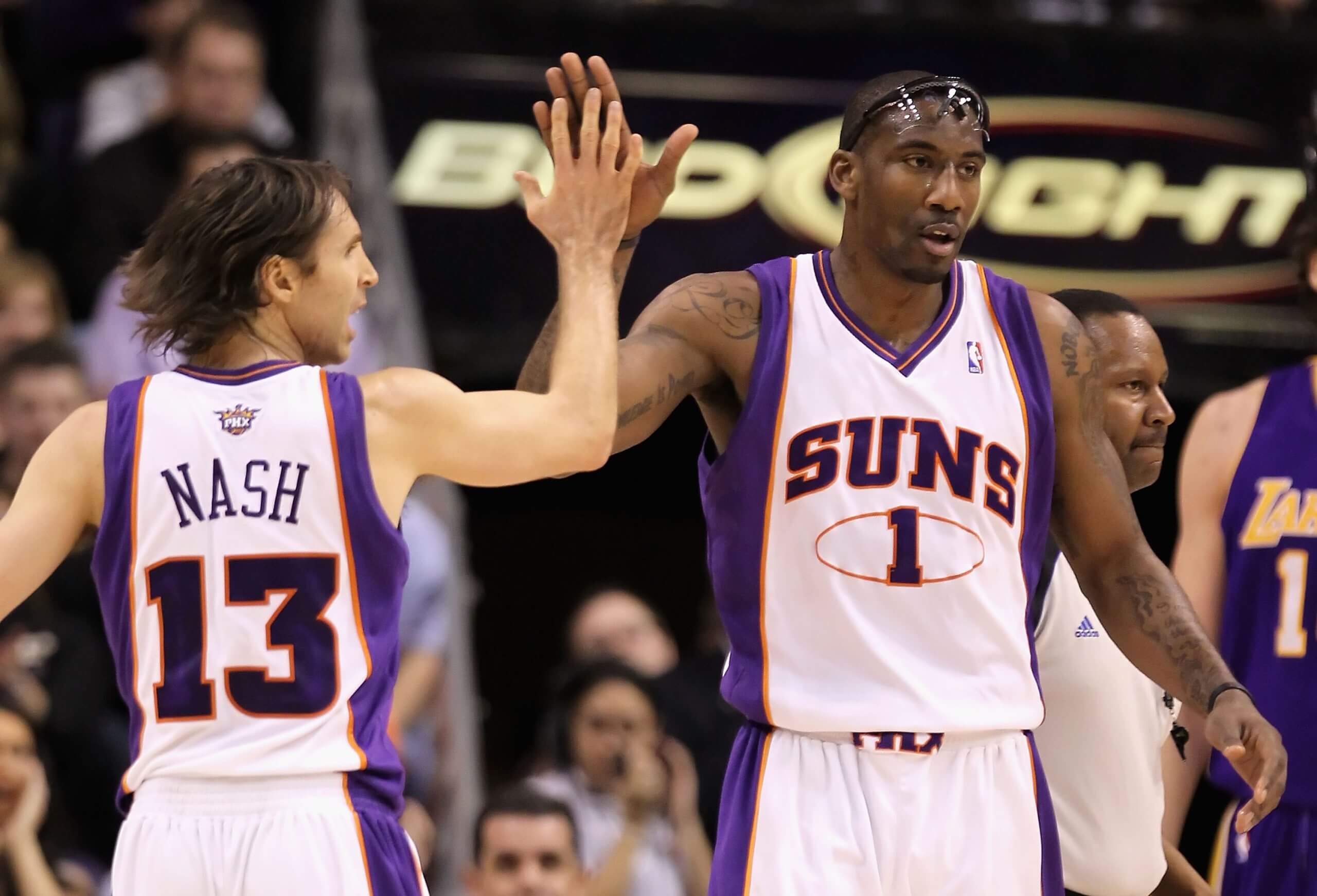 An image of Phoenix Suns players Steve Nash and Amar'e Stoudemire high-fiving each other during an NBA game.