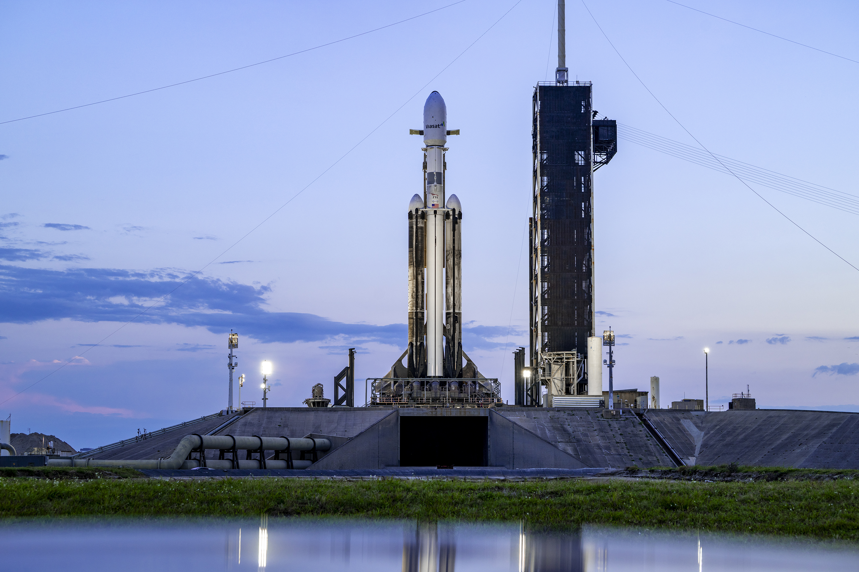 A SpaceX Falcon Heavy sits on the pad at Kennedy...
