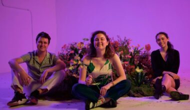 3 young adults sitting with AI gadgets