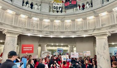 Hundreds of Idahoans gathered in the rotunda of the Idaho Capitol on Jan. 12, 2026, to protest proposed cuts to the state’s Medicaid program. The protest, organized by Idaho Voices for Children, took place before the governor’s State of the State Address.
