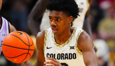 Michigan head coach Dusty May swings the net after winning the NCAA national championship against Connecticut at Lucas Oil Stadium in Indianapolis on Monday, April 6, 2026.