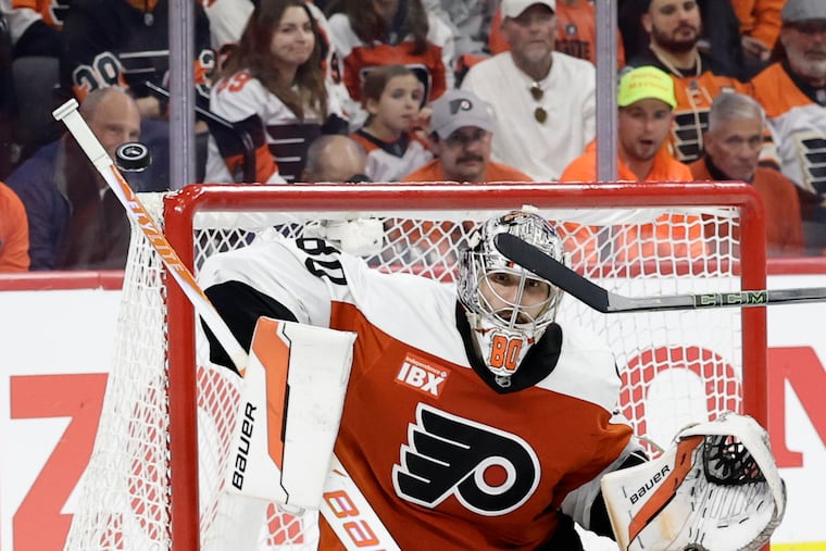Flyers goaltender Dan Vladař uses his stick to deflect the puck against the Pittsburgh Penguins in Game 3.