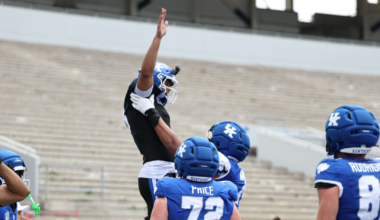 Dec 29, 2025; Fayetteville, Arkansas, USA; James Madison Dukes forward Justin McBride (21) drives against Arkansas Razorbacks forward Trevon Brazile (7) during the second half at Bud Walton Arena. Arkansas won 103-74. Mandatory Credit: Nelson Chenault-Imagn Images