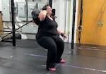 Tristy Taylor has been coming to Prism Moves for about five years. Pictured here on March 30, 2026, Taylor is trying a new way to do squats. She says she enjoys trying new moves with the support of a fitness coach.