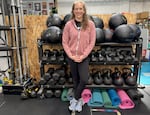 Asher Kondziela stands in front of an equipment rack at the nonprofit gym, Prism Moves, in Portland, Ore., on March 30, 2026.