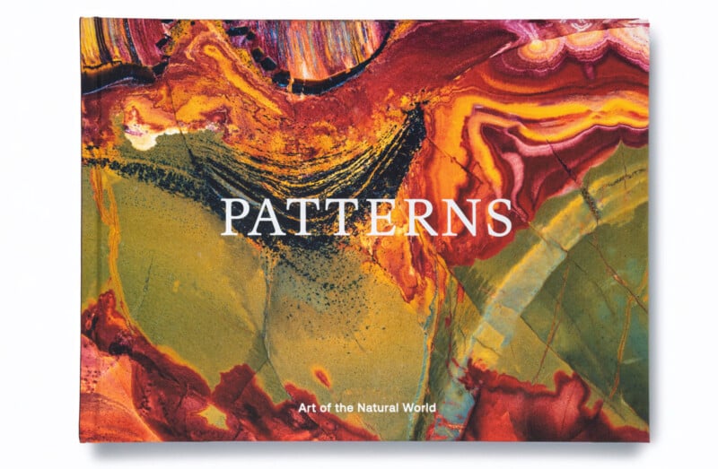 A colorful book cover with abstract natural patterns in red, orange, yellow, green, and black. The title "PATTERNS" is in large white letters, and "Art of the Natural World" is written below in smaller text.