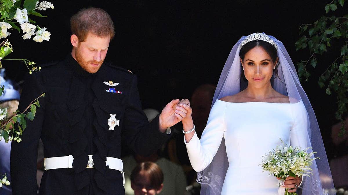 Prince Harry and Meghan Markle wearing their wedding attire after getting married at Windsor.