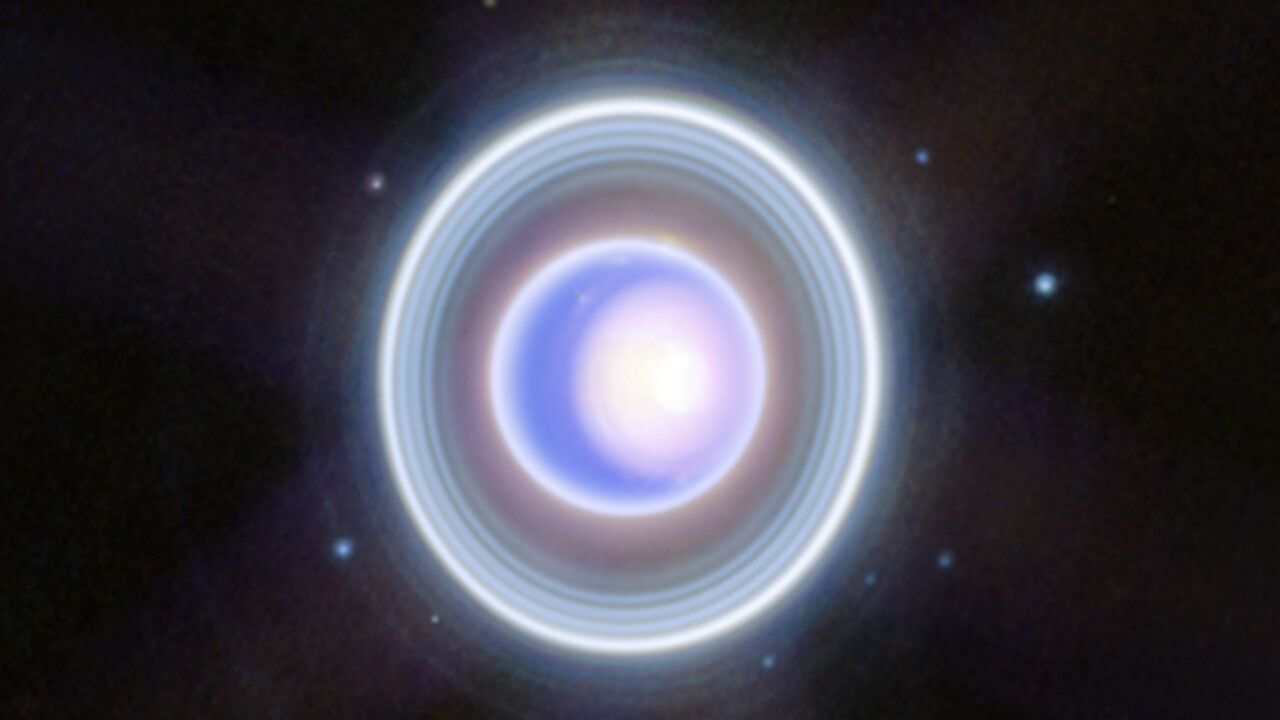 a blue-white orb on a starry background, surrounded by rings of lite
