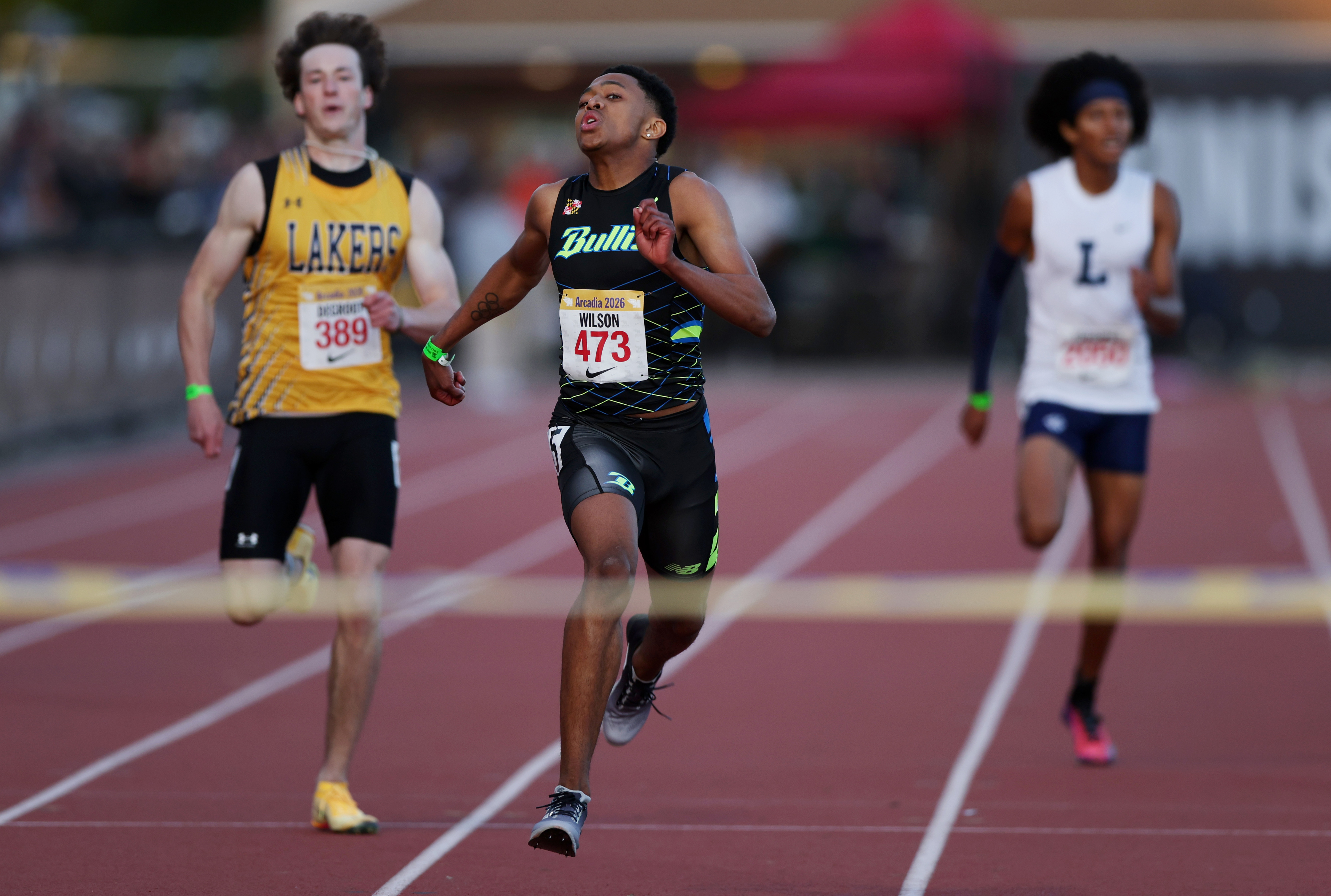 Olympic gold medalist Quincy Wilson, center, competes in the 400...