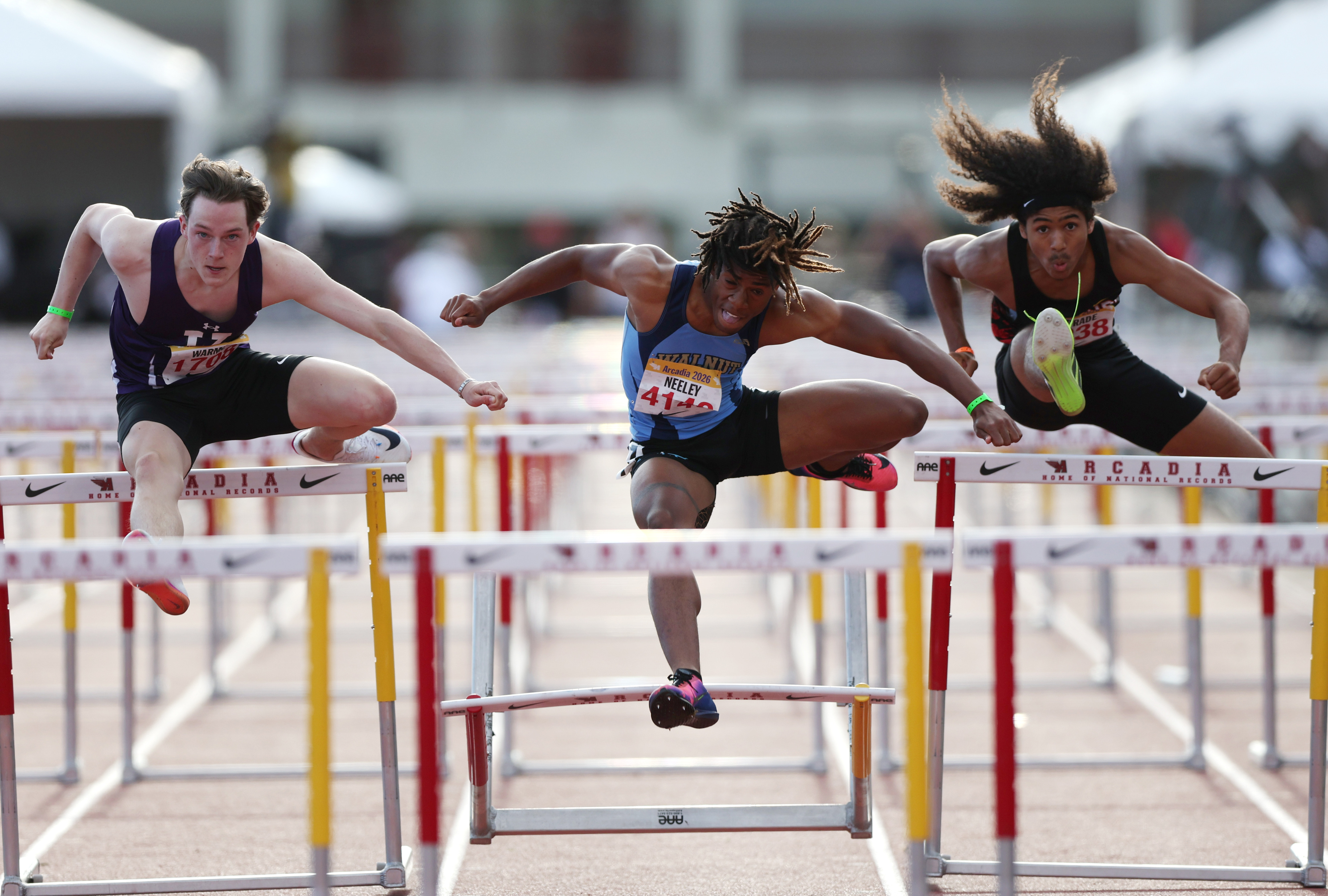 Walnutâs Brendan Neeley, center, competes in the boys 110 hurdles...