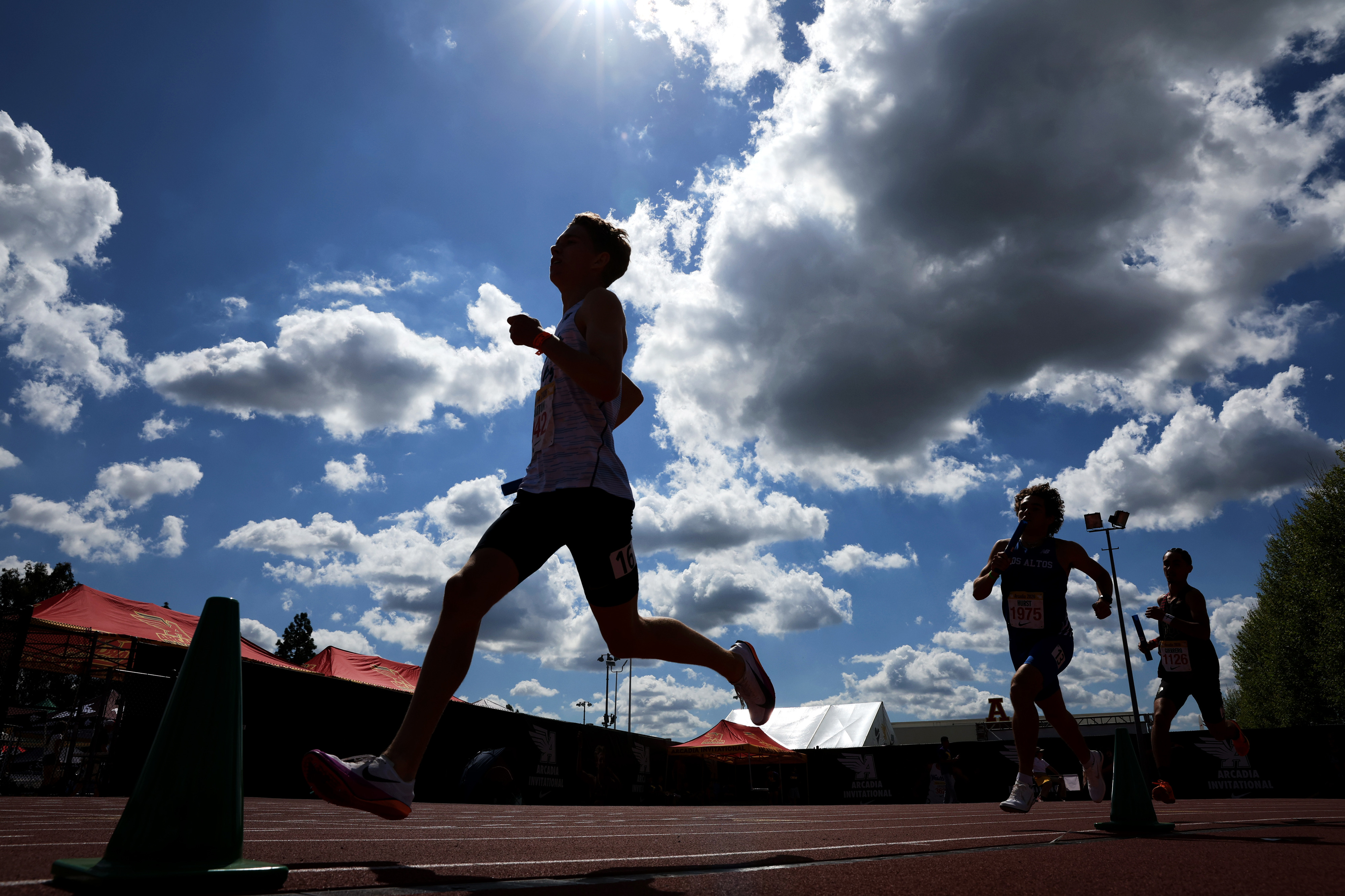 Runners compete in the boys 4×400 relay during the Arcadia...