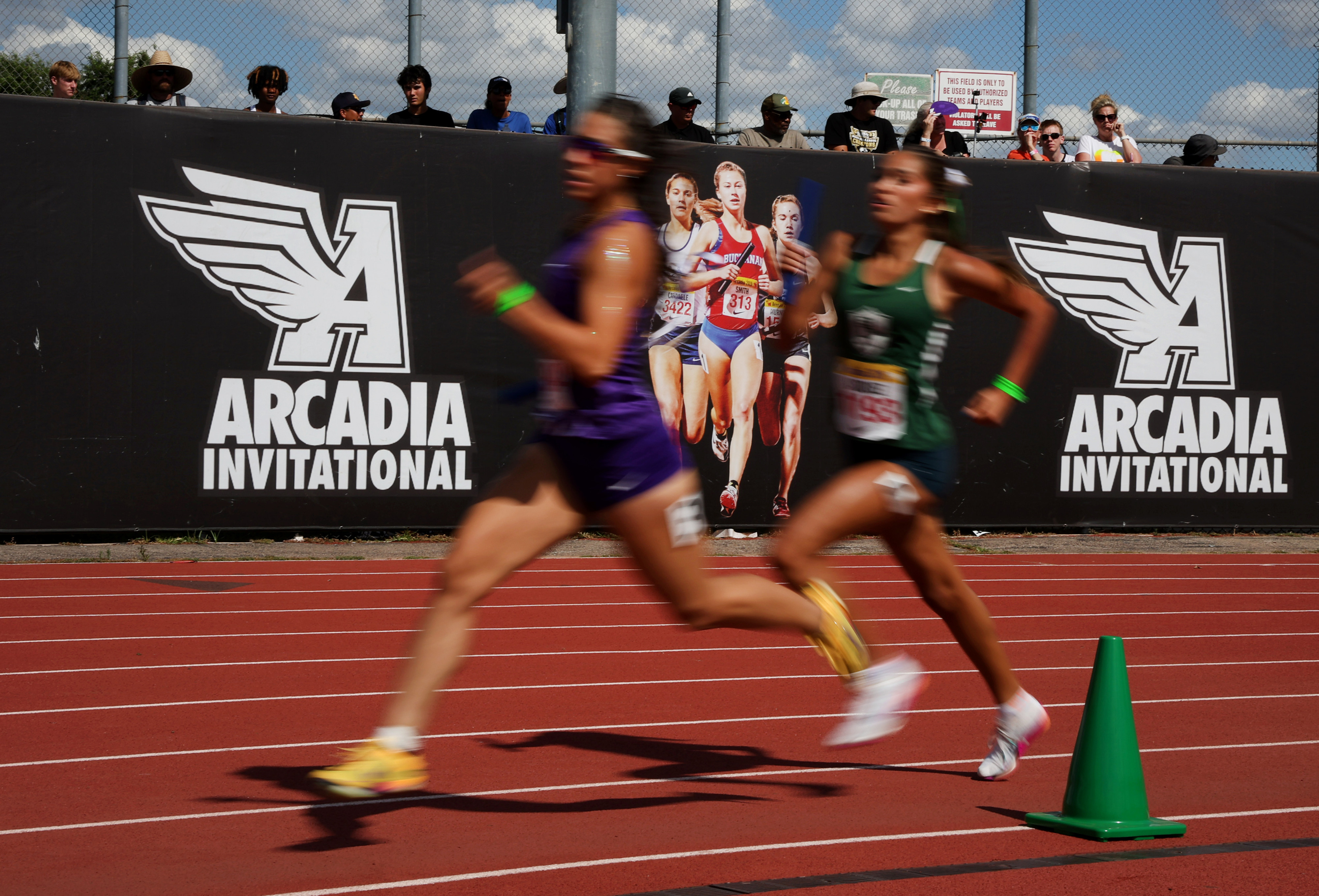 Runners compete in the girls 4×400 relay during the Arcadia...