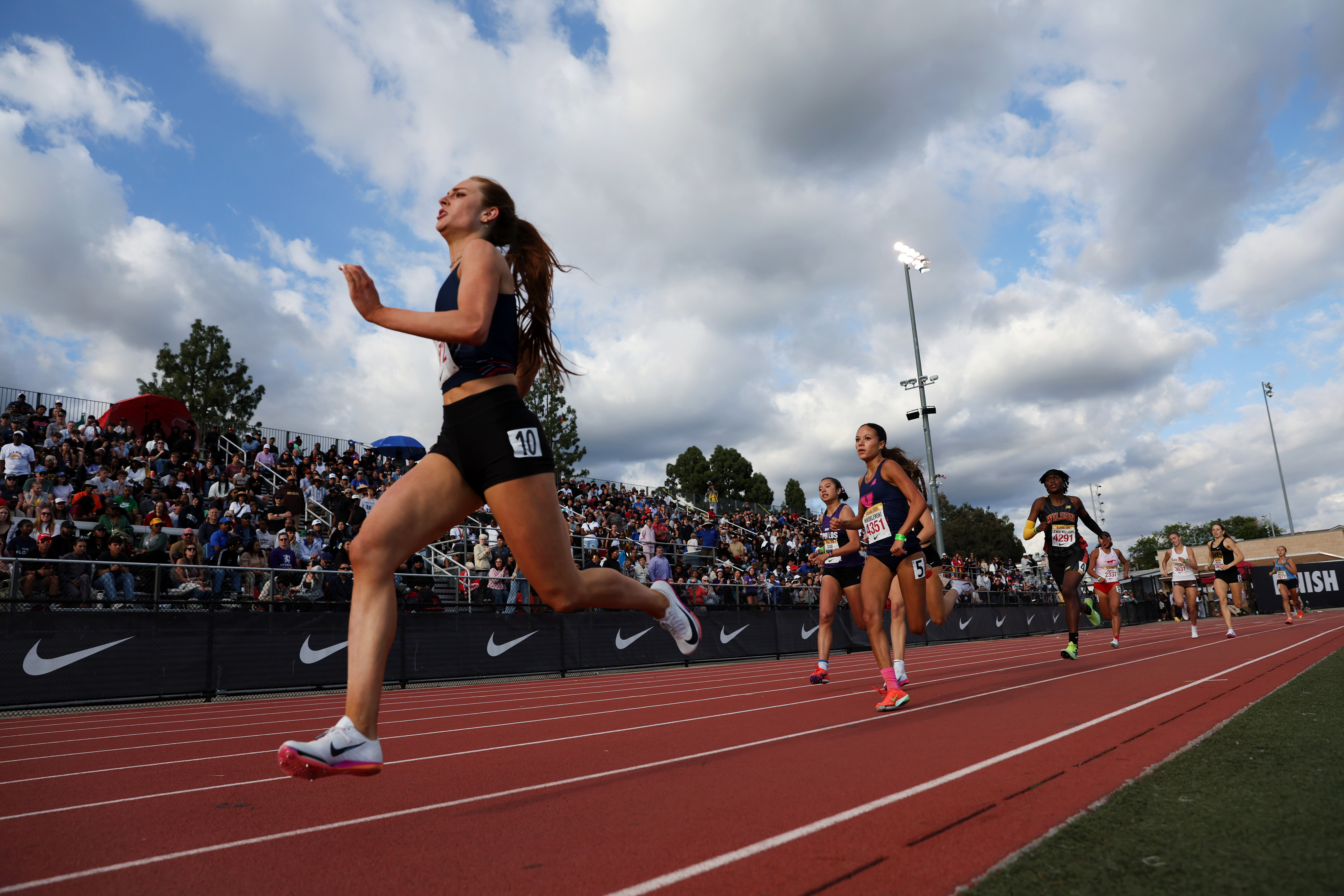 Runners compete in the girls 800 meter run during the...