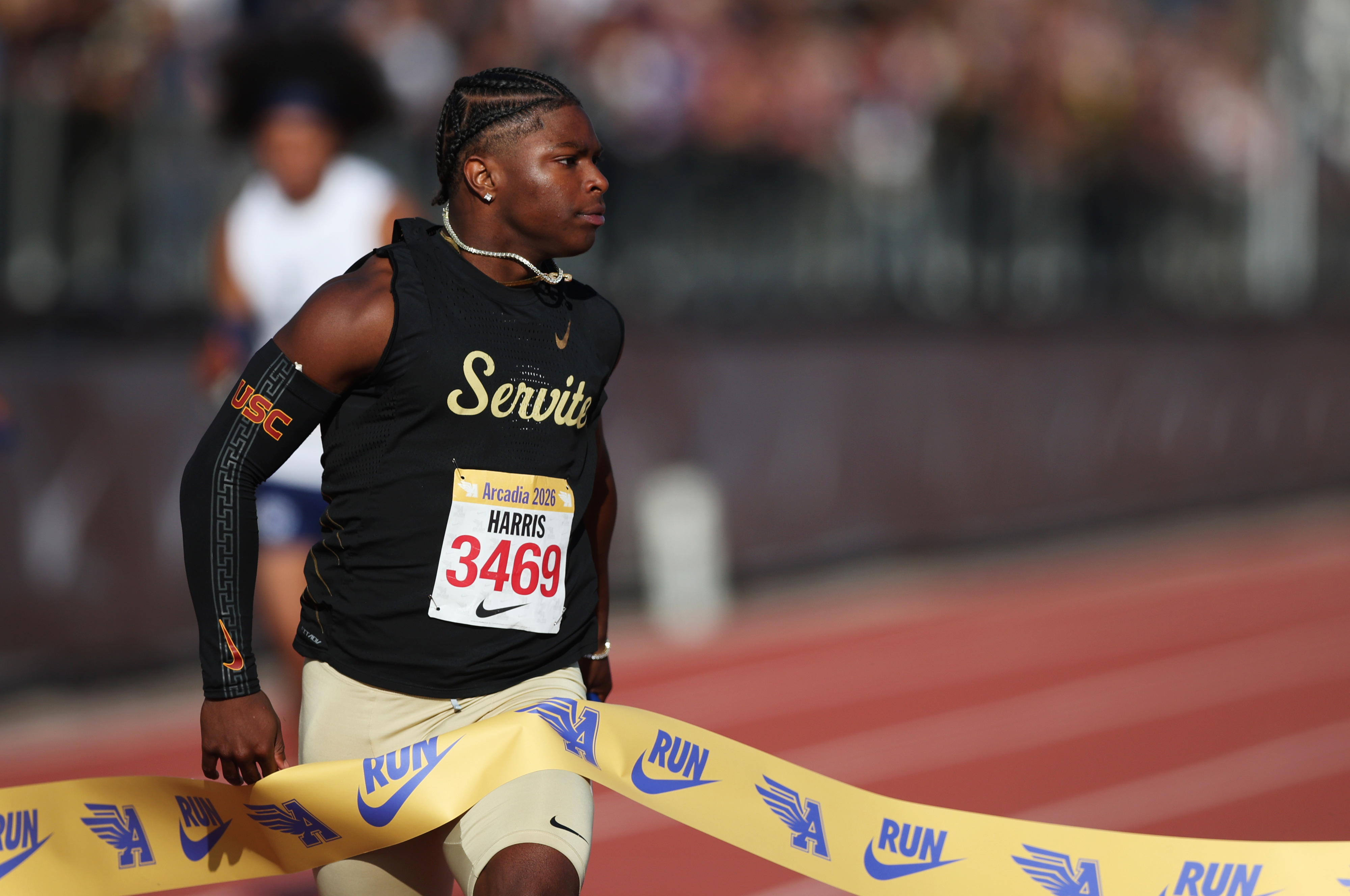 Serviteâs Benjamin Harris crosses the finish line as he and...