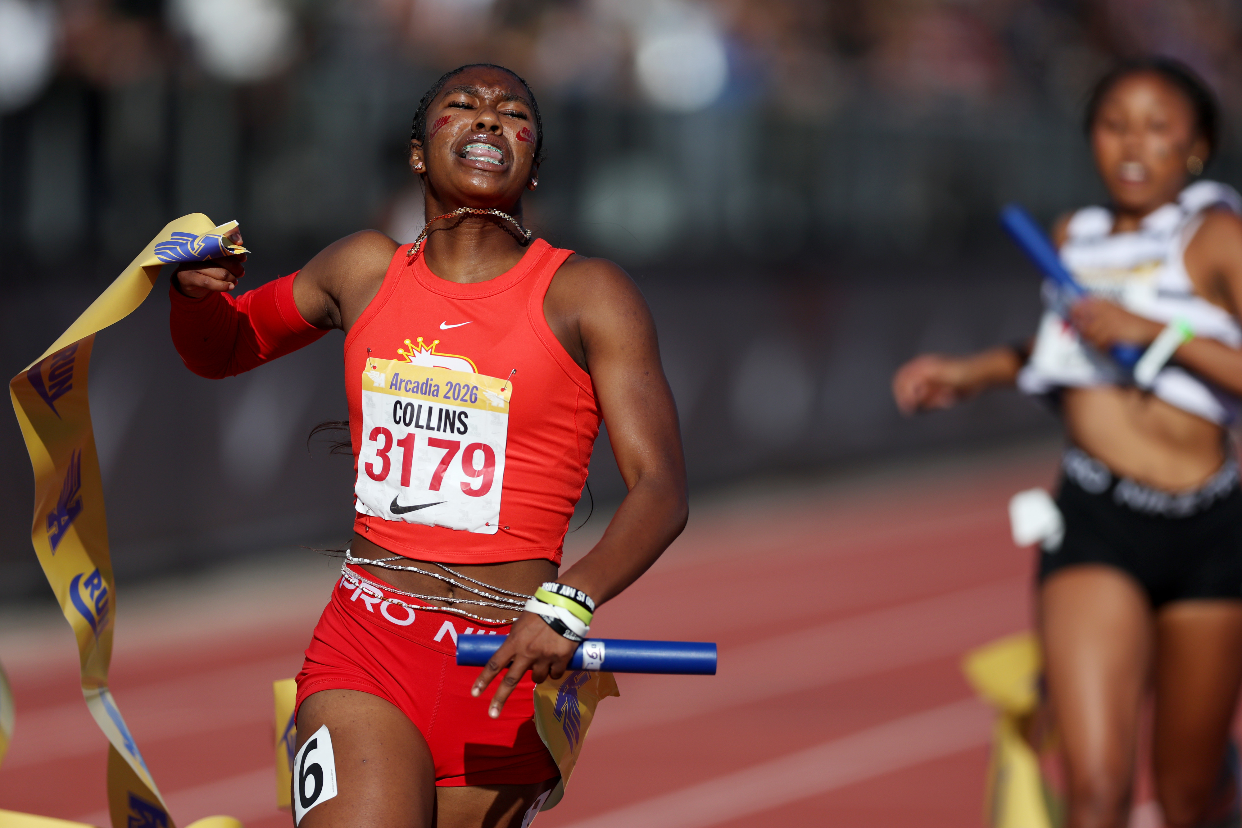 Rosary’s Maliyah Collins celebrates while crossing the finish line in...