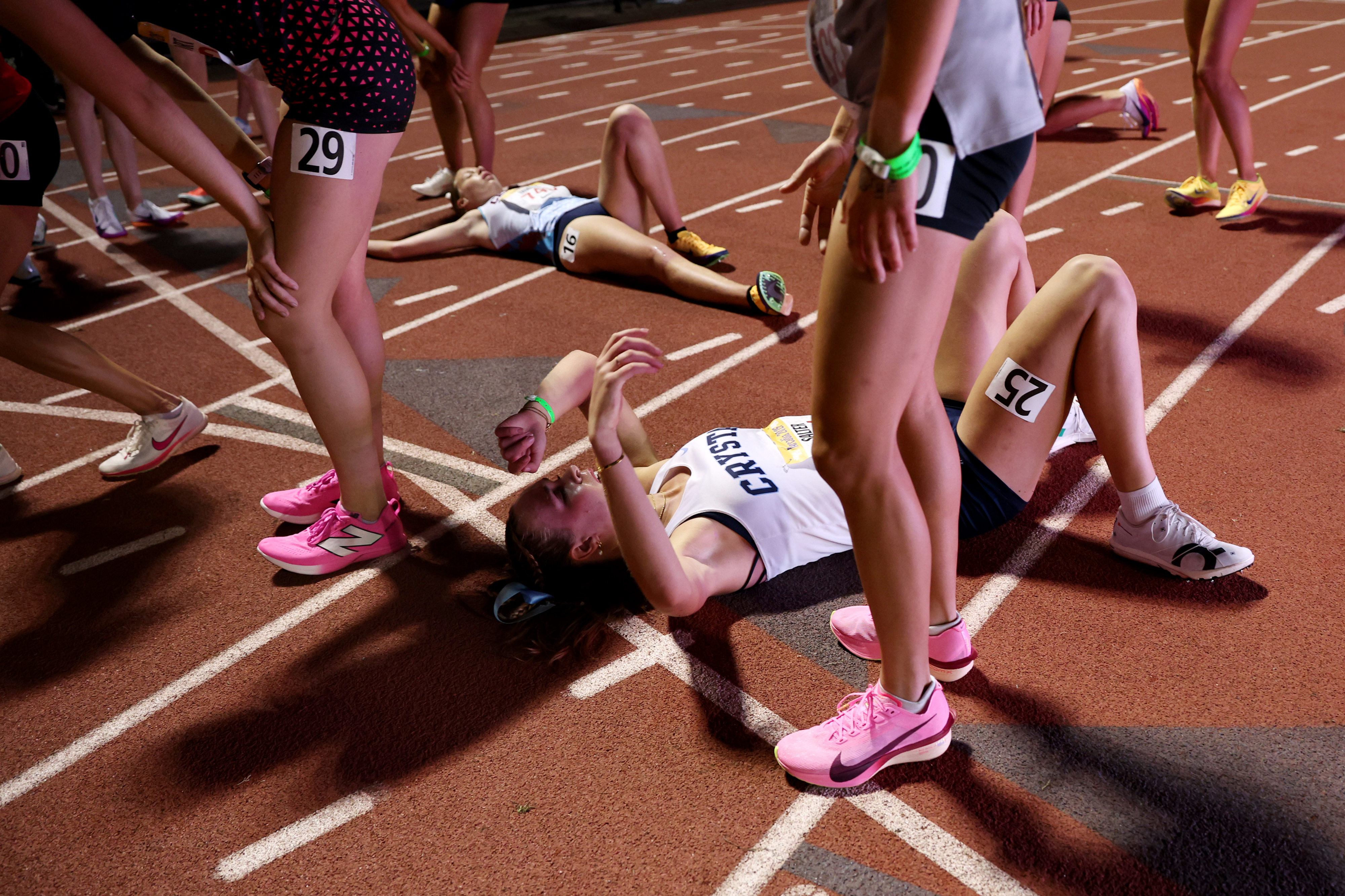 Runners try to catch their breath after finishing the girls...