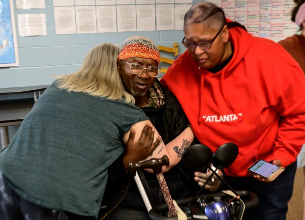 Ralph Coleman gets a hug from fellow club members after becoming emotional while sharing how welcomed and happy he feels at the Vail Communities Clubhouse.