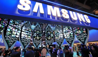 Visitors gather around a Samsung booth with large, leaf-shaped digital displays showcasing vibrant images at a tech convention.
