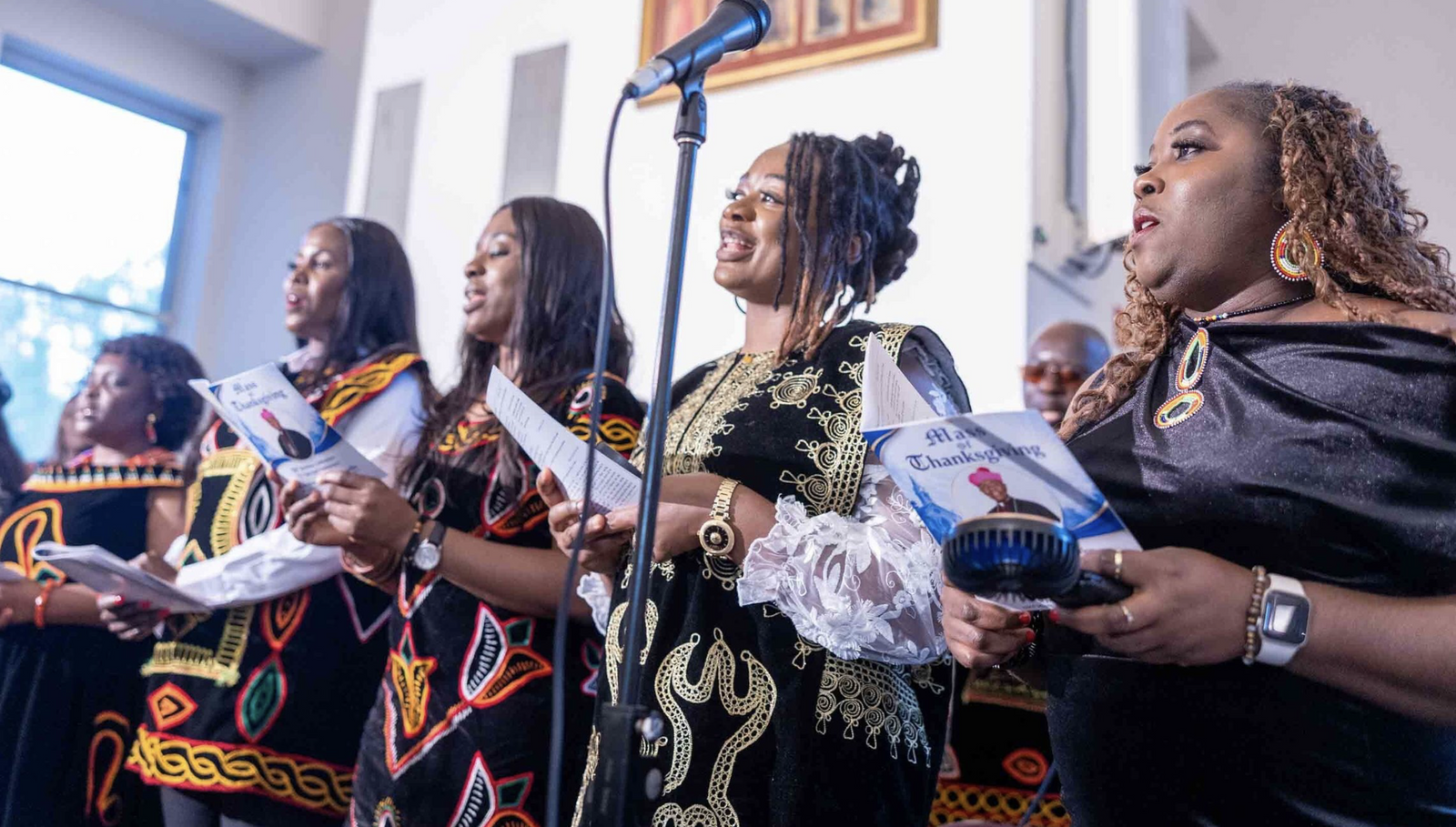 Members of the Holy Trinity Choir of the Cameroonian Catholic community at Resurrection Parish in Burtonsville, Maryland, sing during a Mass of Thanksgiving at St. Joseph Catholic Church in Beltsville on April 17, 2026 that commemorated the 70th birthday of Bishop Jerome Feudjio of the Diocese of St. Thomas in the U.S. Virgin Islands and his fifth anniversary leading that diocese. Bishop Feudjio is a native of Cameroon, one of the African nations that Pope Leo XVI visited that week. (Catholic Standard photos by Mihoko Owada)
