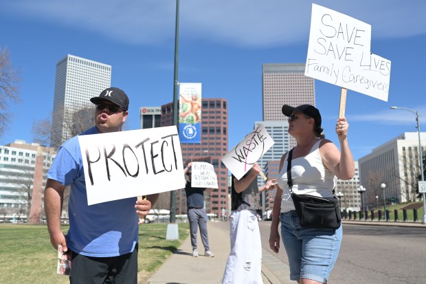 David Gutierrez, left, and his mother Carie Aplanalp and families of people with developmental disabilities protested cuts to their services at Civic Center Park in Denver on Wednesday, March 25, 2026. (Photo by Hyoung Chang/The Denver Post)