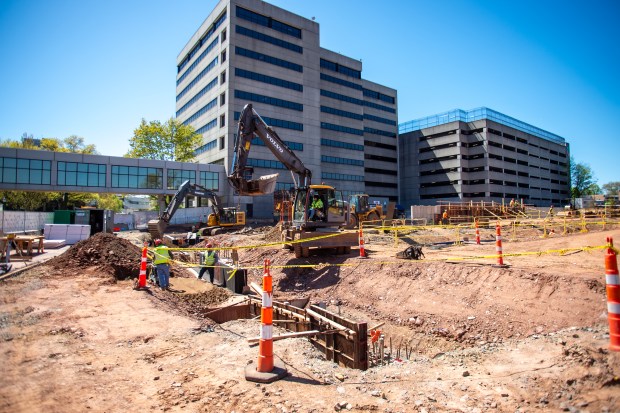 Contractors from Consigli Construction work on the foundation at the new parking garage site at Hartford Hospital. (Aaron Flaum/Hartford Courant)