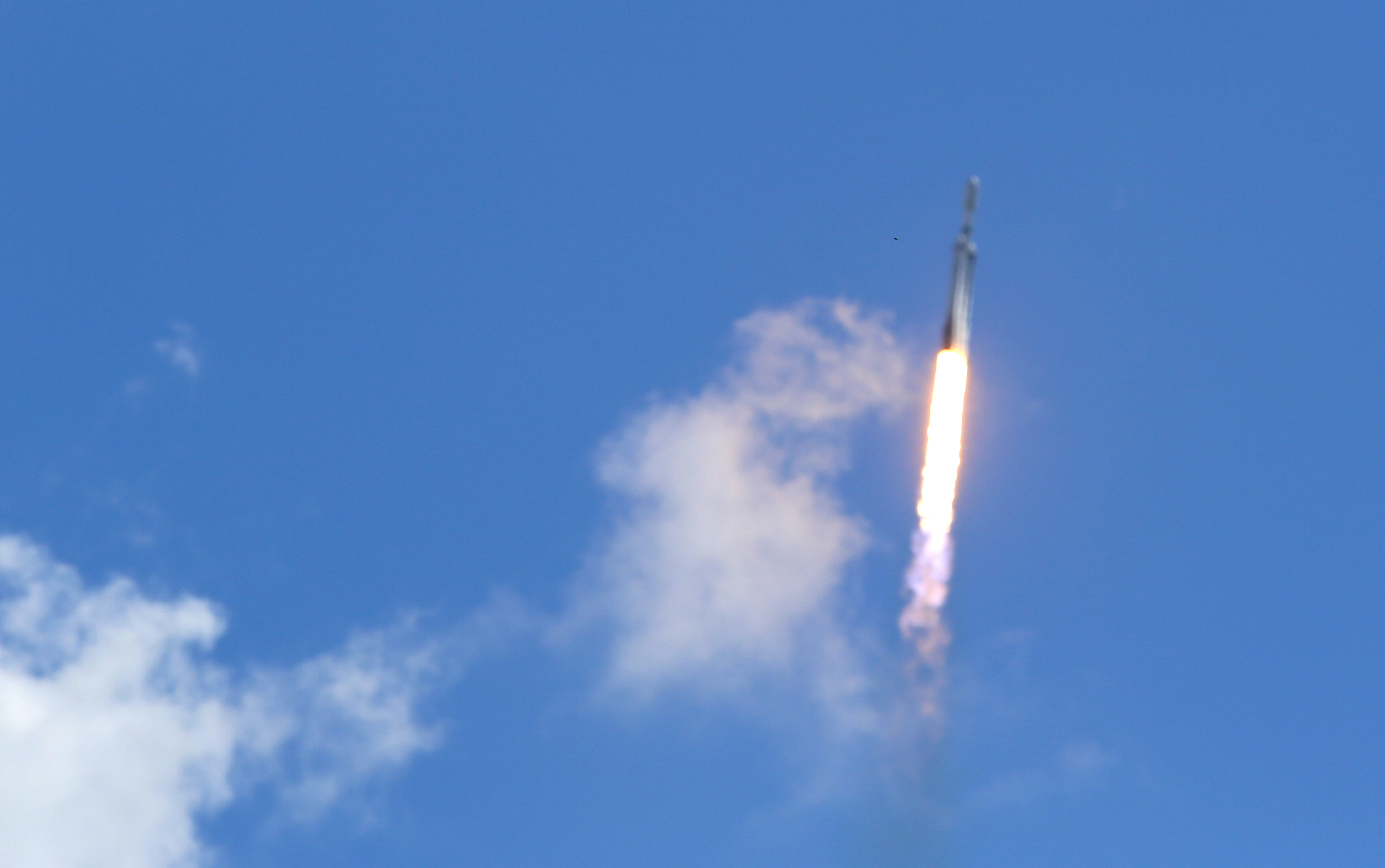 A SpaceX Falcon Heavy rocket launches from Kennedy Space Center's...