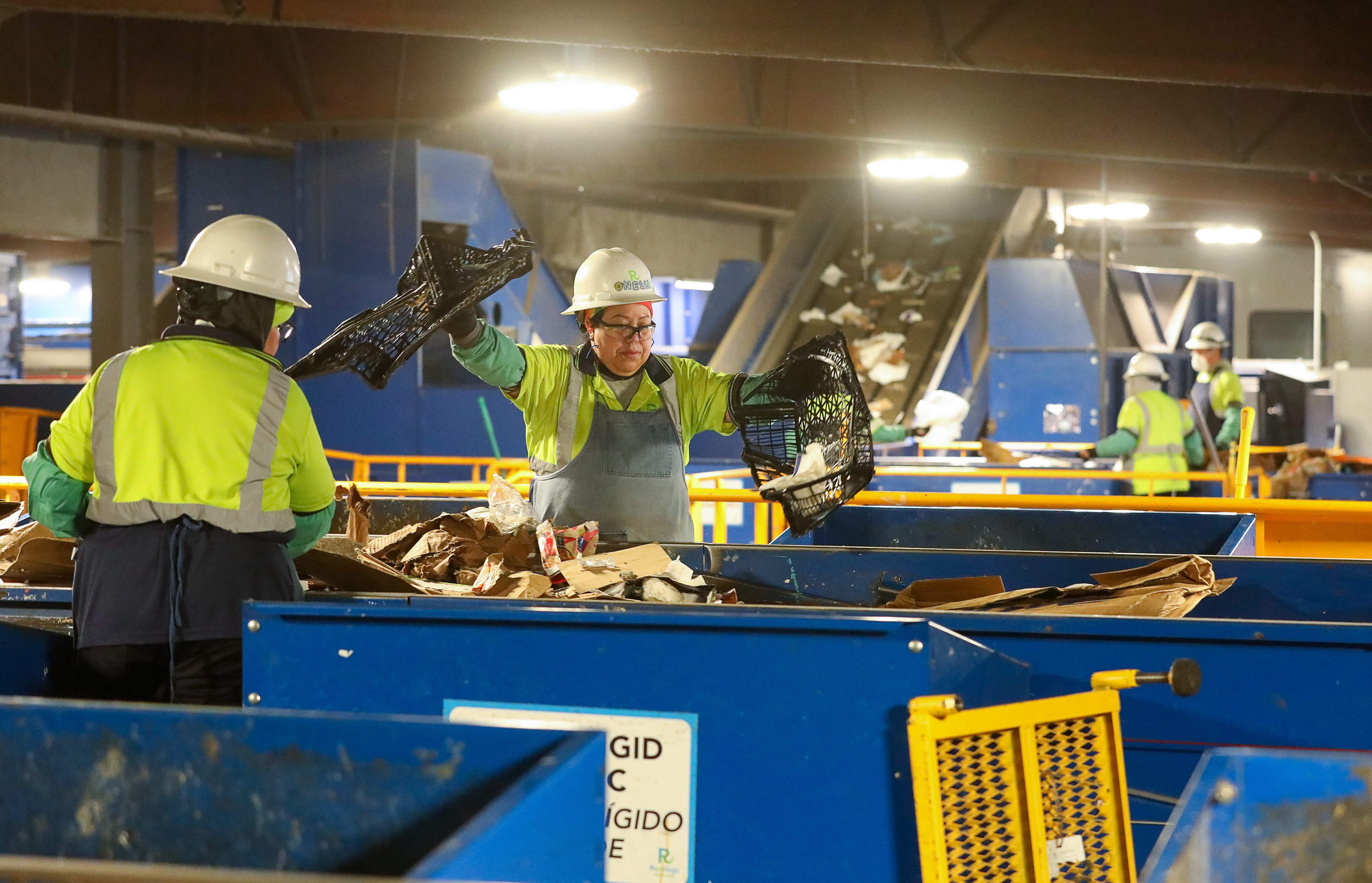 Recology workers remove contaminants from the stream of recoverable materials...