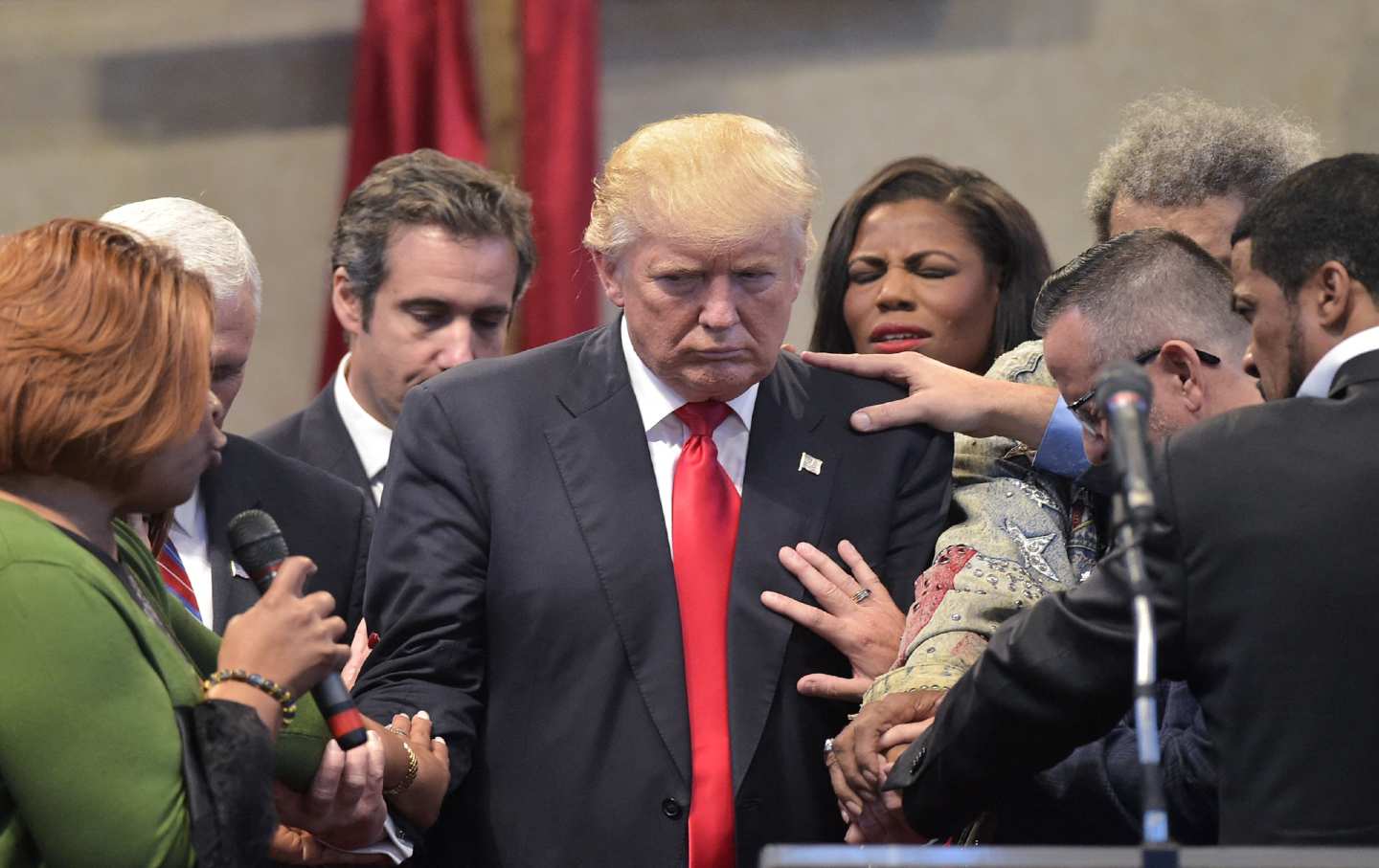 A group of pastors praying over 2016 GOP presidential candidate Donald Trump at the Midwest Vision and Values Pastors and Leadership Conference at the New Spirit Revival Center in Cleveland Heights, Ohio.